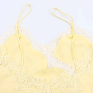 Close-up of light yellow V-neck lace camisole with delicate eyelash lace trim detail