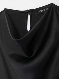 Detail of black satin sleeveless top featuring a cowl neck and back button closure