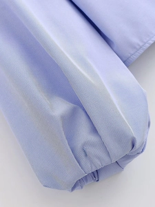 Detailed macro shot of fine blue and white stripes with neat ruffled edge stitching