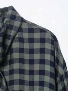 Detail of navy and sage green checkered shirt fabric with smooth cotton texture