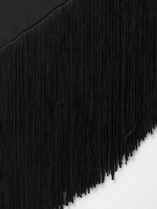 Detailed close-up showing the dense black fringe texture and smooth fabric on the top hem