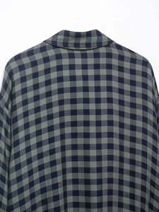 Detail of green and blue gingham check pattern on high-quality cotton shirt fabric