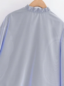Close-up of elegant blue and white striped shirt featuring a delicate pie-crust collar