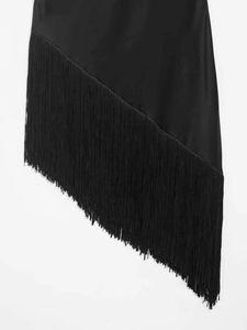 Close-up of black sleeveless top featuring elegant diagonal fringe and satin fabric detail