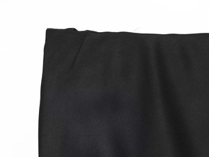Detail of black twill fabric with satin lace hemline on a summer fashion skirt