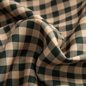 Macro view showing the texture of green and khaki gingham fabric with twill weaving