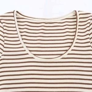 Detail of the scoop neckline with brown and beige stripes on a casual summer knit t-shirt