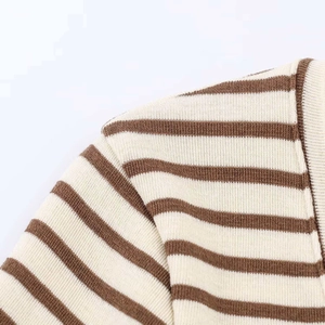 Macro shot of brown and beige striped knit fabric showing ribbed texture and seam details
