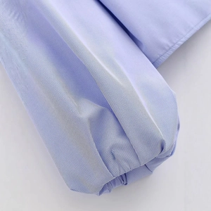 Light blue and white vertical striped shirt with elegant ruffle V-neck and ruffled cuffs