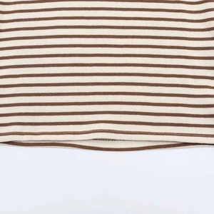 Detailed close-up of brown and cream striped knit hem with durable double-stitched seams