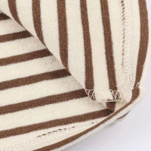 Detailed close-up showing precision stitching and texture of brown striped knit fabric