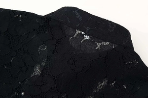 Close-up of black floral lace fabric with intricate mesh patterns and exquisite hollow texture