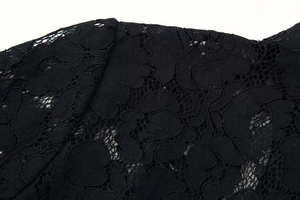 Close-up of black lace fabric with delicate floral embroidery and sheer texture detail