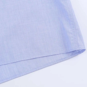 Detailed macro view of light blue shirt fabric texture and professional double stitching