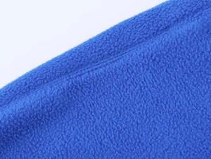 Macro shot of blue fleece fabric texture and stitching details for winter jacket