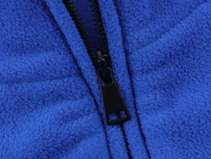Close-up of high-quality zipper and soft royal blue fleece texture on winter jacket
