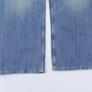 Detailed macro shot of light blue denim fabric texture and double-stitched reinforced seams