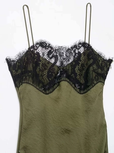 Detail of olive green satin dress with black eyelash lace neckline and side zipper