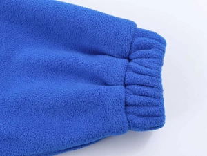 Detail view of the elastic ribbed cuff on a soft blue polar fleece ski jacket
