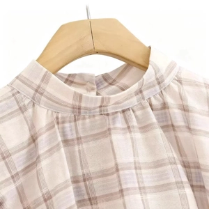 Women's plaid sleeveless top with high neck and back button in beige and purple tones