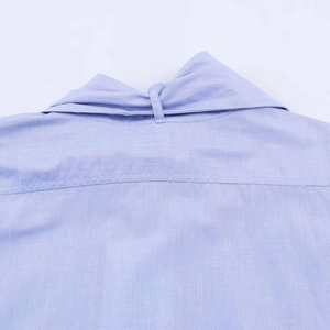 Detail view of light blue shirt collar and back yoke with premium fabric texture