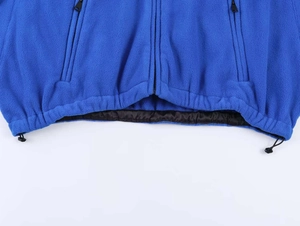 Detail of royal blue fleece jacket hem featuring adjustable drawstring and toggles