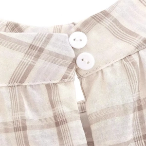 Plaid sleeveless top featuring a keyhole neckline with double white buttons and cotton texture