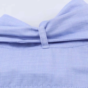 Macro detail of fine blue striped fabric showing high-quality waistband stitching and texture