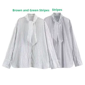 Close-up of striped poplin shirts with bow neckties and buttoned cuffs details