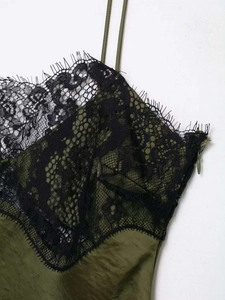 Detail of olive green satin dress featuring black floral eyelash lace and slim straps