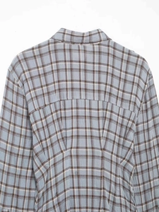 Detailed back view of a light blue plaid shirt dress showing collar and shoulder stitching