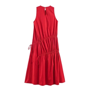 Detail of red sleeveless midi dress showing drawstring ruched texture and woven fabric