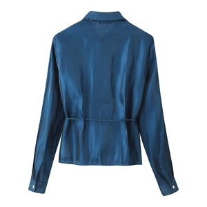 Detail view of glossy blue satin shirt back showing tie-waist design and silver buttons