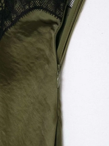 Detail view of military green dress showing lace trim and hidden side zipper