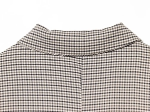 Detail shot of vintage brown plaid wool blend texture on a loose fit blazer jacket