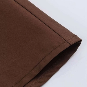 Detailed macro shot of the double-needle stitching on high-density brown twill midi skirt