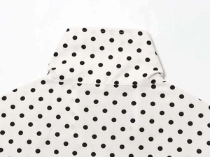 Detail view of white polka dot chiffon jacket collar and shoulder stitching quality