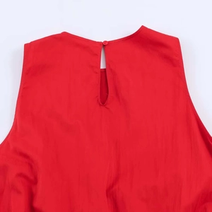 Macro detail of red dress featuring rear teardrop cutout and single button closure