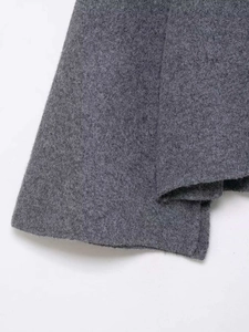 Macro shot of dark grey thick knit fabric with textured grain and soft wool finish
