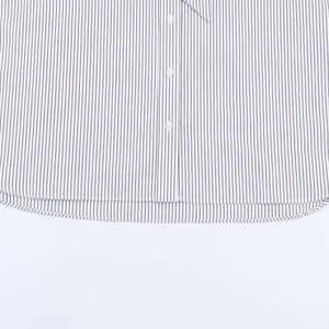 Close-up of striped poplin shirt featuring resin buttons and curved hem detail