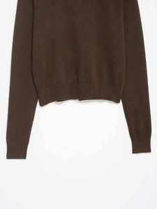 Detailed view of dark brown knitted cardigan showing fine knit texture and ribbed cuffs