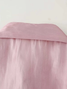 Detail of pink semi-transparent silk shirt collar with a soft glossy texture and fine weave