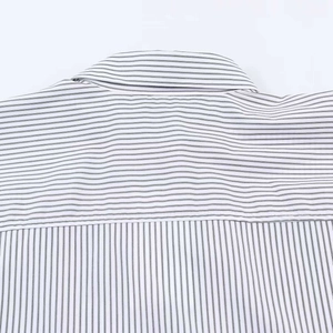 Close-up of the striped poplin shirt collar showing high-quality stitching and fabric texture