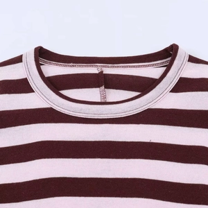 Detailed macro view showing the ribbed crew neck and brown striped jersey fabric texture