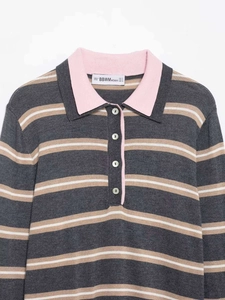 Close-up of pink polo collar and grey striped knit texture on women's sweater