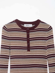 Close-up of stripes and buttoned V-neck collar on women's knit sweater top