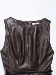 Detail view of a brown faux leather sleeveless top with an elegant gold buckle belt