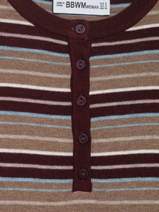 Detail view of V-neck collar with buttons and stripe pattern on knit sweater