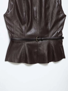Detail of dark brown leather peplum top with black belt and golden metal buckle