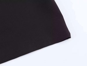 Close-up of black polo shirt fabric texture with high-quality stitching on the bottom hem